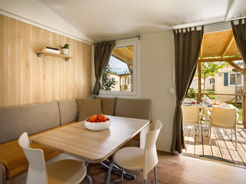 Zona pranzo del lodge San Marino Home al Valamar Camping San Marino in Croazia, con tavolo e sedie moderne.