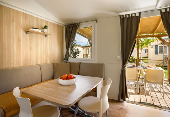 Zona pranzo del lodge San Marino Home al Valamar Camping San Marino in Croazia, con tavolo e sedie moderne.