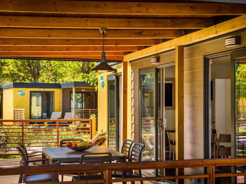 Charming terrace at Lopar Garden Home, Valamar Camping San Marino in Croatia, featuring seating and greenery.