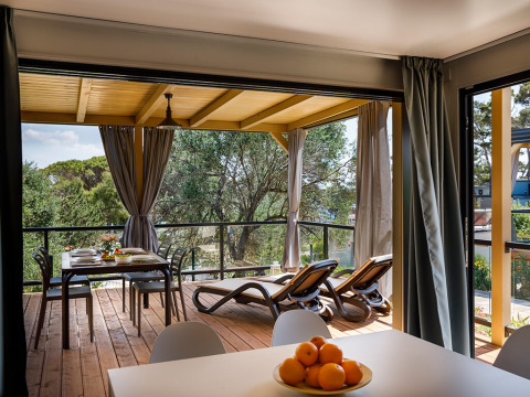 View from Padova Suite at Valamar Camping Padova, Croatia, featuring a terrace with a dining table and loungers.