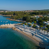 Luchtfoto van de kust bij Krk in Primorje-Gorski Kotar, Kroatië, met kiezelstrand en helder water.