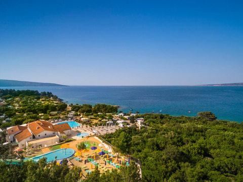 Vista aerea di Valamar Camping Krk con piscine, aree verdi e mare in Primorje-Gorski Kotar, Croazia.