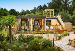 Bella Vista Home Garden terrace at Valamar Camping Krk in Croatia, surrounded by lush greenery and trees.