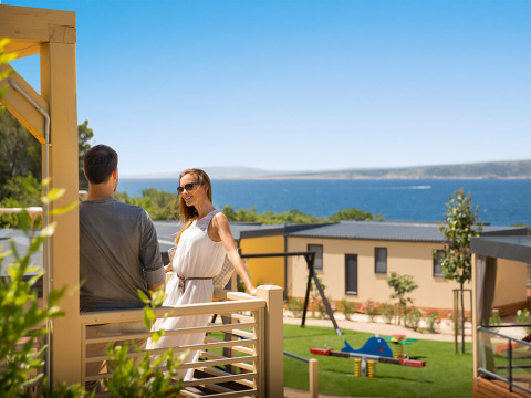 Couple profitant de la terrasse Bella Vista Home Garden au Valamar Camping Krk avec vue sur la mer en Croatie.