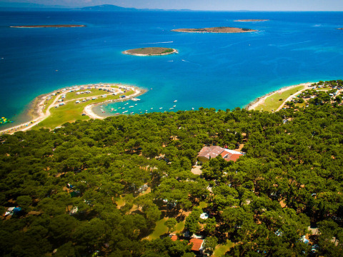 Aerial view of Camping Arena Stupice in Istria, Croatia, showing coastline, islands, and pine forest.
