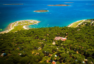 Vista aerea di Camping Arena Stupice in Istria, Croazia, con costa, pineta e piccole isole.