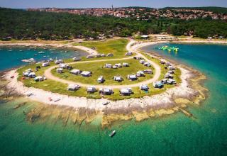 Aerial view of Camping Arena Stupice in Istria, Croatia with campers near the clear blue Adriatic sea.