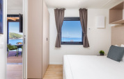 Bright bedroom with sea view at Camping Home Sea View, Camping Arena Stupice, Croatia.