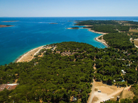 Vista aérea de Camping Arena Stupice en Istria, Croacia, con costa, mar turquesa y áreas boscosas.