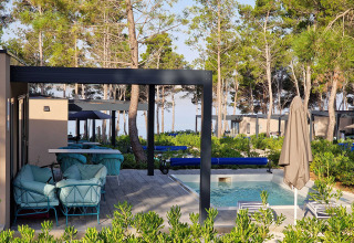 Espace extérieur avec piscine et salons entouré de verdure à Aminess Style Camping Avalona Resort, Croatie.