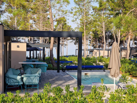 Modernes Ferienresort in Zadar mit Sitzbereich, Pool und Pinienbäumen beim Aminess Style Camping Avalona Resort.