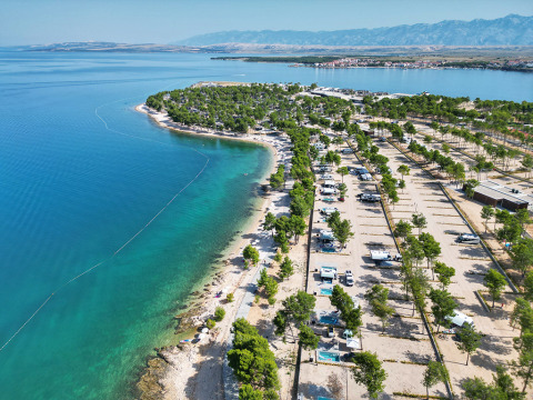 Aerial view of Aminess Style Camping Avalona Resort on the coast of Zadar County, Croatia, by the clear sea.