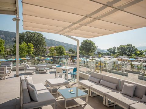 Zona lounge esterna moderna presso Valamar Camping Baška in Croazia, con divani e vista sulle montagne.