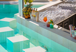 Modern pool bar with colorful cocktails, fruit and glassware at Aminess Style Camping Atea Resort Croatia.