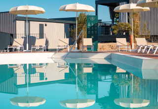 Outdoor pool at Aminess Style Camping Atea Resort in Primorje-Gorski Kotar, Croatia, with loungers and umbrellas.