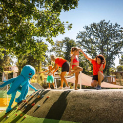 Børn og voksne leger på legepladsen i Aminess Style Camping Atea Resort under solrige omgivelser i Kroatien.
