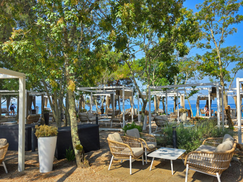Outdoor lounge area with modern wicker chairs and sea view at Aminess Style Camping Atea Resort, Croatia.