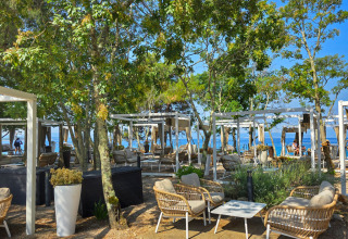 Outdoor lounge area with modern wicker chairs and sea view at Aminess Style Camping Atea Resort, Croatia.