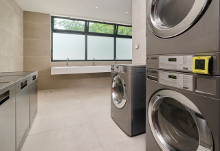 Modern laundry room with several washers and dryers at Aminess Style Camping Atea Resort in Croatia.