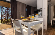 Modern dining area inside Camping Home Green chalet with juice and table setting, Arena Grand Kažela, Croatia