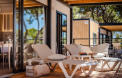 Modern terrace with sun loungers and lounge furniture at Camping Villa, Camping Arena Stoja, Croatia.