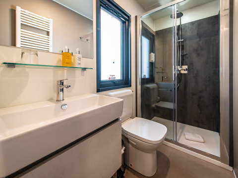 Modernes Bad mit Dusche, WC und Waschbecken in der Camping Villa auf dem Camping Arena Stoja, Kroatien.