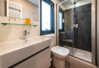 Bagno moderno con doccia, wc e lavabo nella Camping Villa al Camping Arena Stoja, Croazia.