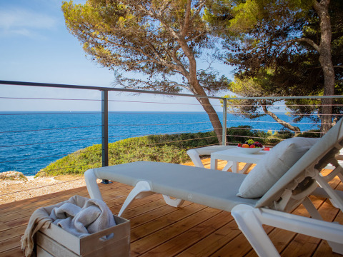 Terrasse détente avec transats, vue sur la mer et arbres à Deluxe Camping Villa Sea View, Camping Arena Stoja.