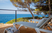 Relaxing deck with loungers, sea view, and trees at Deluxe Camping Villa Sea View, Camping Arena Stoja, Croatia.