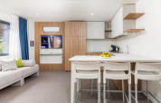Modern living room and kitchen at Deluxe Camping Villa Sea View, Camping Arena Stoja, Croatia.