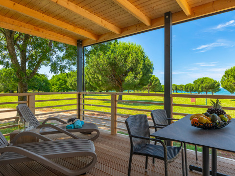 View from Park Riviera Adria Blue Seaside lodge at Camping Park Umag, Croatia, showing terrace and seaside landscape.