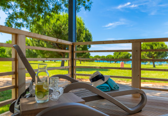 Relaxing terrace at Park Riviera Adria Blue Seaside, Camping Park Umag, with lounger, drinks, and sunny view.