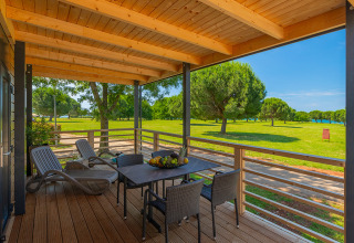 Terrasse en bois avec table, chaises et transats au Park Riviera Adria Blue Seaside, Camping Park Umag, Croatie.