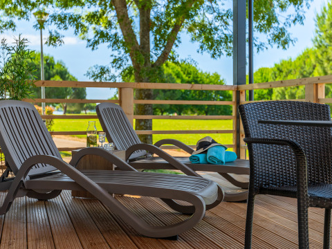 Terrazza soleggiata con lettini e tavolo al Park Riviera Adria Blue Seaside, Camping Park Umag, Croazia.