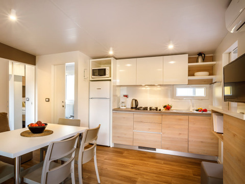 Modern kitchen and dining area at Lopar Garden Home in Valamar Camping San Marino, Croatia, bright interior.