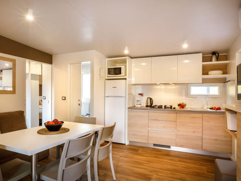 Modern kitchen and dining area at Lopar Garden Home, Valamar Camping San Marino, Croatia, with bright decor.