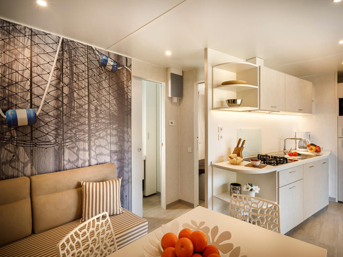 Modern kitchen and dining area inside Marena Home lodge at Valamar Camping Baška, Croatia, with bright decor.