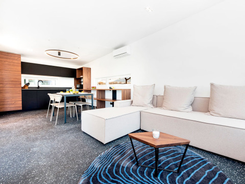 Moderne familielodge met open leefruimte, eettafel en keuken bij Camping Porton Nature Hideouts in Kroatië.