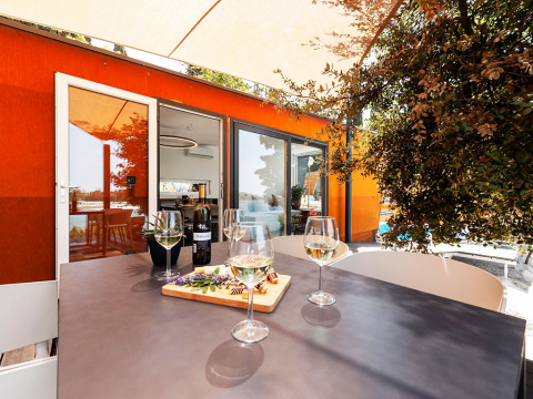Mesa exterior con copas de vino en Family Holiday Home Pool, Camping Porton Nature Hideouts, Croacia