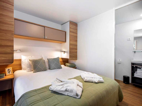 Modern bedroom in a Porton lodge at Camping Porton Nature Hideouts, Croatia, featuring a double bed.