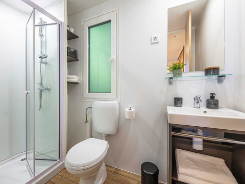 Modern bathroom with shower, toilet and sink at Porton lodge, Camping Porton Nature Hideouts, Croatia.
