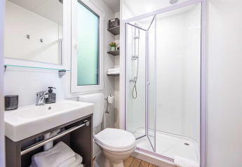 Lyst og moderne badeværelse i Porton lodge ved Camping Porton Nature Hideouts, Kroatien, med brusekabine.