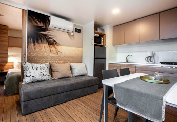 Moderne lodge ved Porton Pool, Camping Porton Nature Hideouts, Kroatien med køkken og stue.