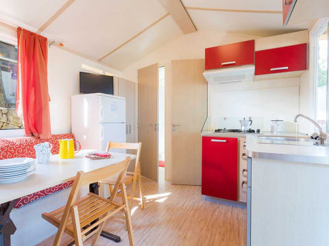 Bright, modern kitchen and dining area of the Blu Romantic lodge at Baia Holiday Poljana, Croatia.