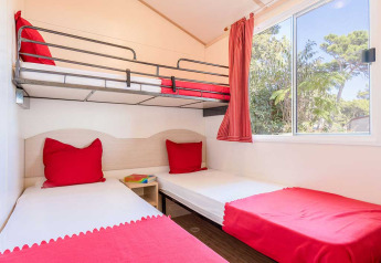 Chambre lumineuse au Blu Romantic, Baia Holiday Poljana en Croatie, avec lits simples et lit superposé.