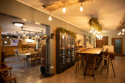 Cozy restaurant interior at Camping Fuussekaul in Wiltz, Luxembourg, featuring warm lighting.