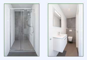 Baño moderno con cabina de ducha y sanitario suspendido en lodge de Hofparken Wiltershaar, Países Bajos.