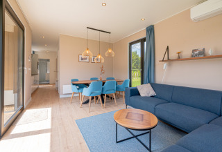 Bright living room in Water lodge 6 Deluxe with sauna and hot tub at Hofparken Wiltershaar, Netherlands.