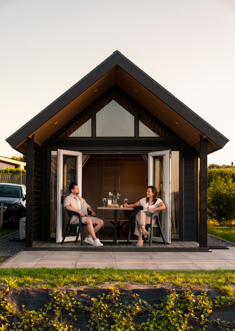 Dos personas relajándose en la terraza de Berg Lodge - Sauna en Resort Mooi Bemelen en los Países Bajos.