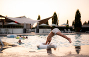 Niño zambulléndose en la piscina de Biebosch - tuinhuis en Resort Mooi Bemelen, Países Bajos, al atardecer.